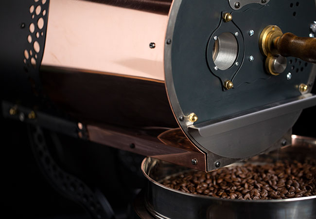 close up view of jake coffee roaster front panel depicting small viewport and sample trowel.