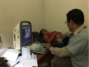 doctor performing an ultrasound on a woman