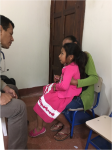 doctor speaking to young female patient