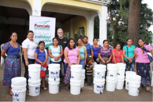 Joseph Behm with group of women receiving water filtration systems