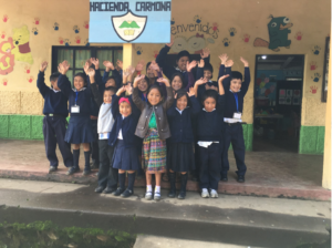 group photo of kids in front of their school